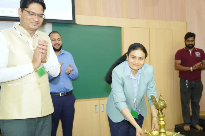 Lighting a ceremonial lamp at the opening of the Faculty Development Programme
