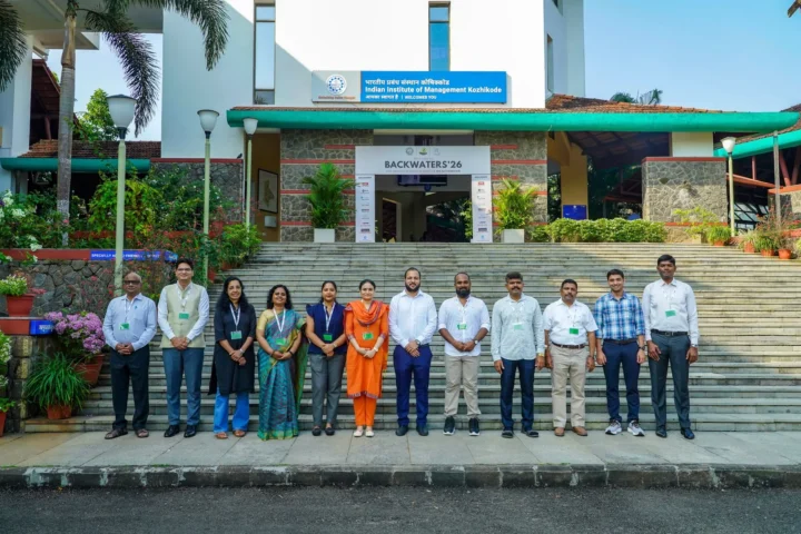 The Faculty Development Programme cohort standing on the steps of the building
