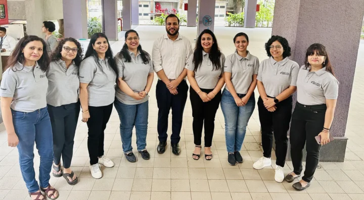 A group of programme participants in matching shirts standing together