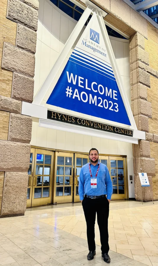 Standing beneath the Welcome AOM2023 banner outside the Hynes Convention Center
