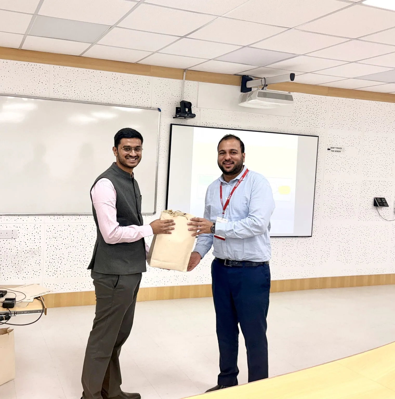 Handing over a memento at the front of a room