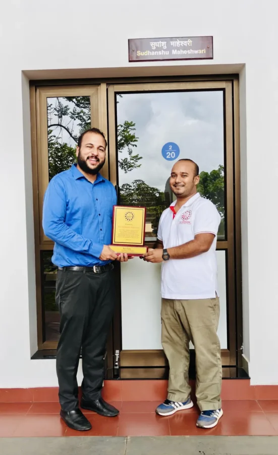 Presenting a framed memento to a colleague beside a doorway