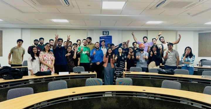 Participants raising their hands in a tiered classroom