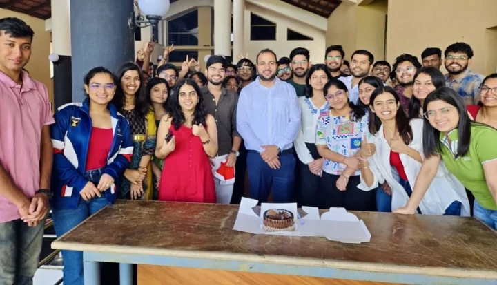 A group of students gathered around a table at a celebration