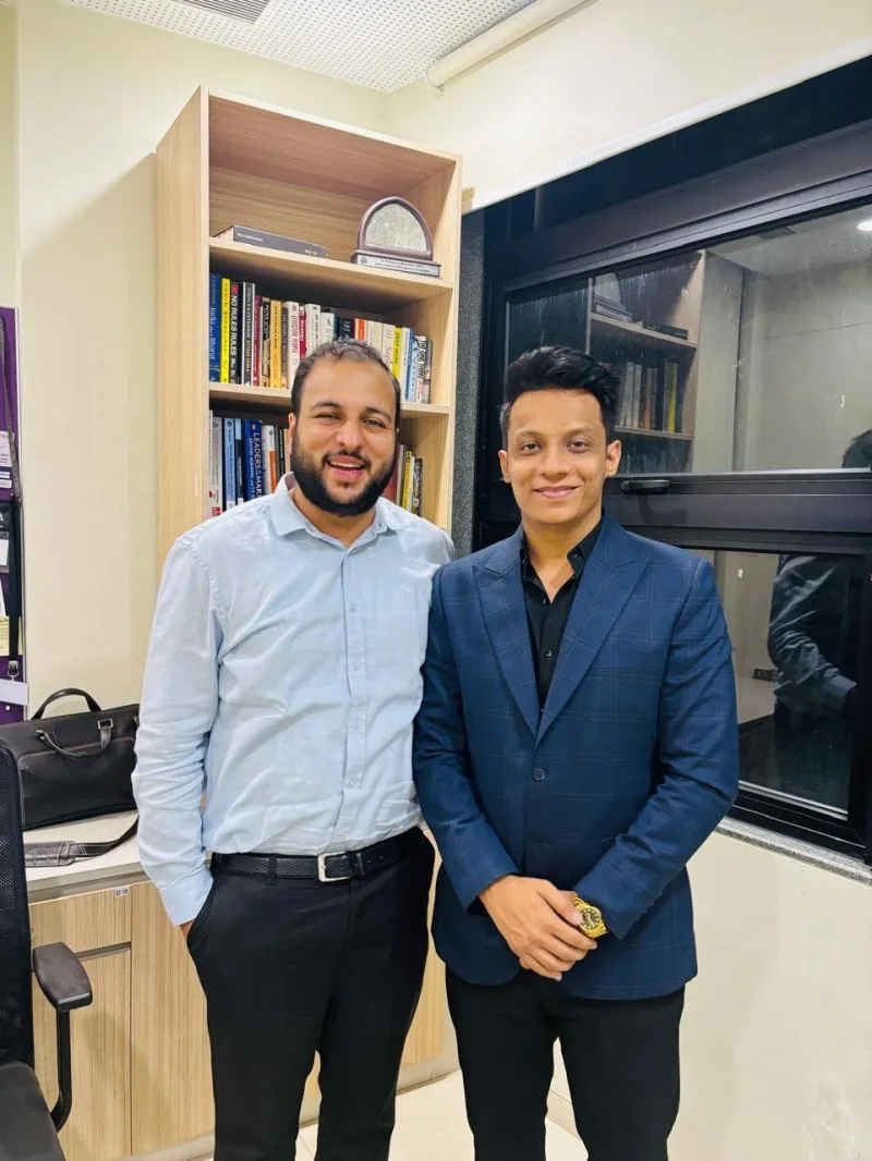 Two people standing together in an office