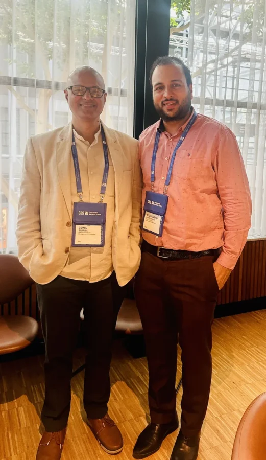 Two delegates standing together in a conference lounge