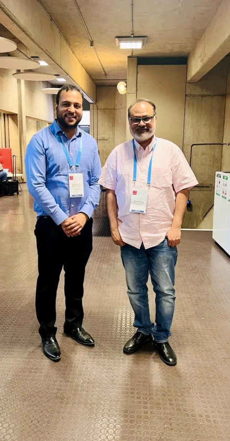 Two conference delegates standing in a convention centre corridor