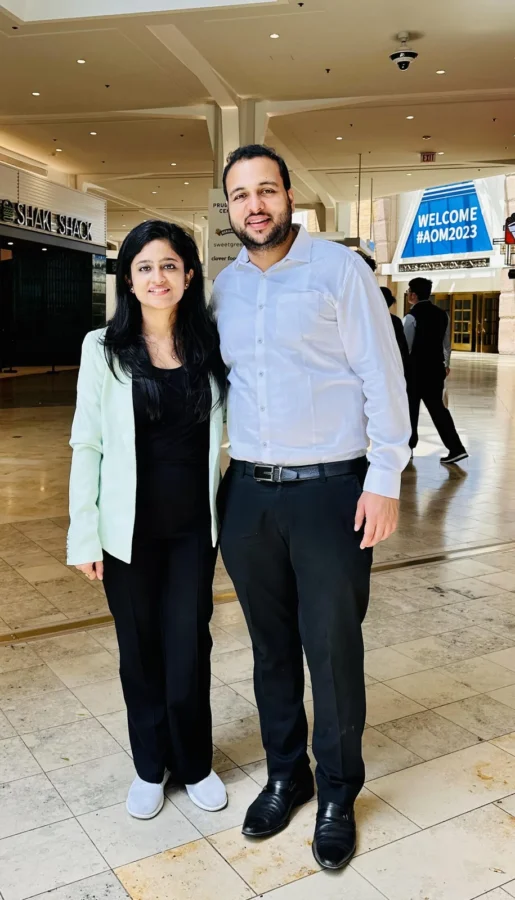 Two conference delegates standing in a convention centre concourse