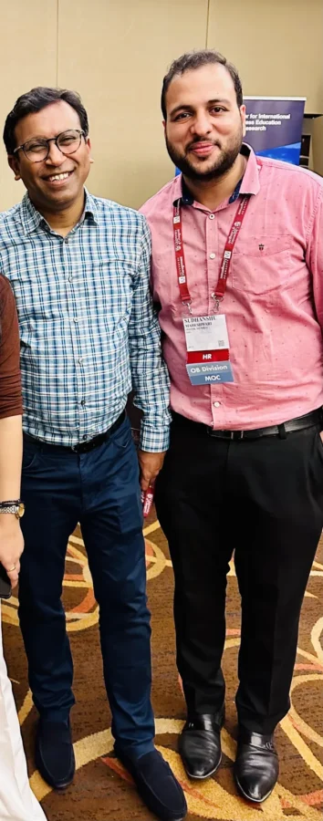 Two conference delegates standing side by side