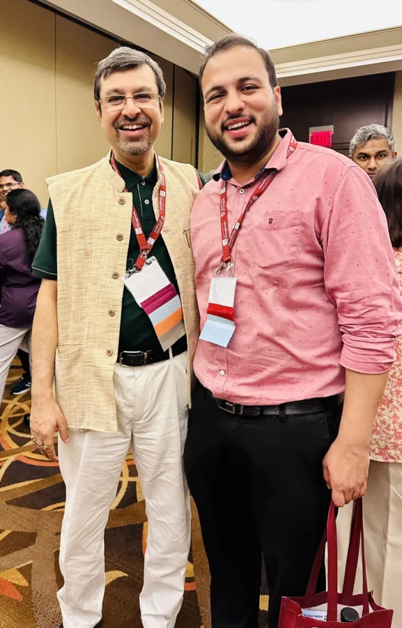 Two delegates standing together following a conference session
