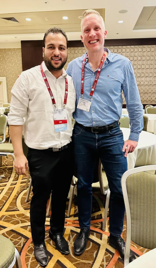 Two conference delegates standing together in a conference hotel