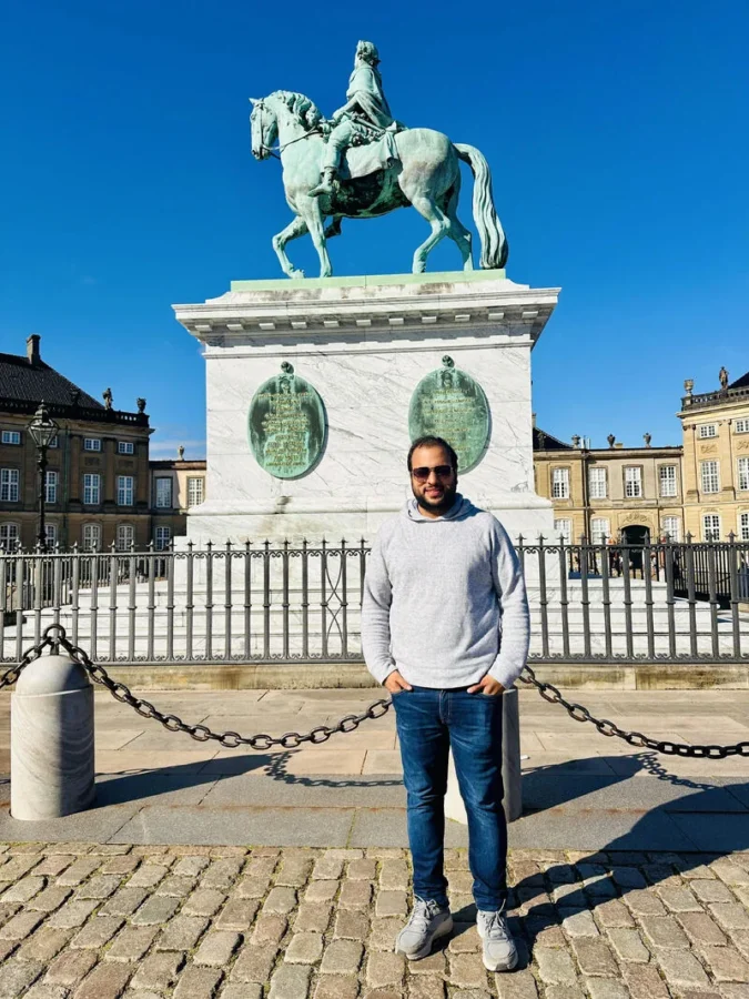 Standing in front of an equestrian statue in a city square