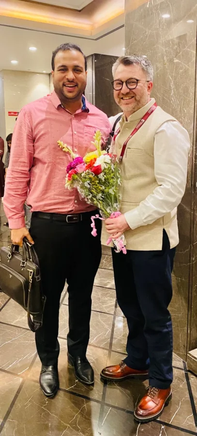 Holding a bouquet with a colleague in a conference foyer