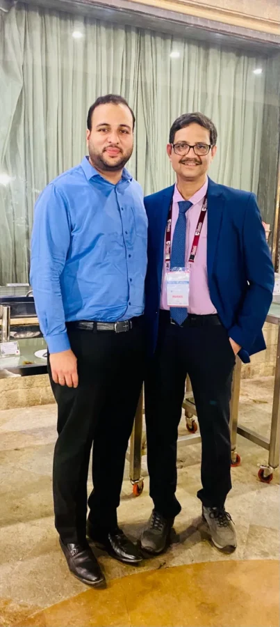 Two delegates standing together at the conference venue