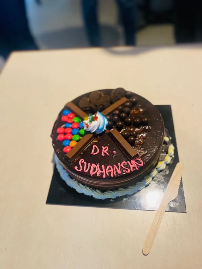A chocolate cake iced with the words Dr Sudhanshu