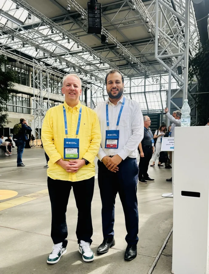 Two delegates standing in a large exhibition hall