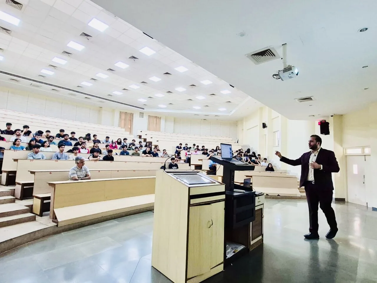 Addressing a full tiered lecture hall from the front