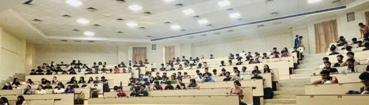 A full lecture hall of students seated for the guest lecture