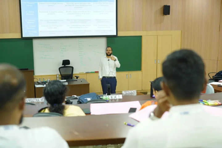 Addressing a seated group from the front of a classroom